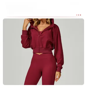 Detail of burgundy zip-up hoodie featuring dropped shoulders and high-waisted gym leggings