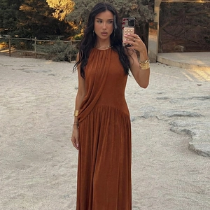 Detail of a brown sleeveless dress showing the gathered neck and soft velvet texture