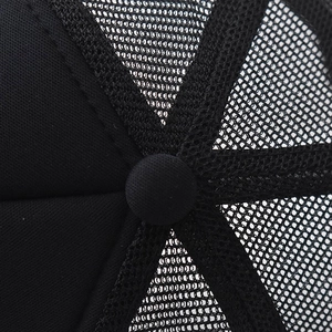 Close-up detail of the crown and top button on a black mesh trucker cap showing fine stitching