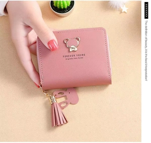Pink short wallet with cute golden bear plaque, bunny charm and long tassel details