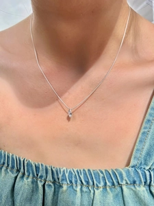 Detail of s925 silver marquise-cut zircon necklace worn on a woman's collarbone