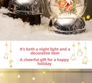 Macro shot of a Christmas snow globe with Santa, reindeer, and sled on a snowy base