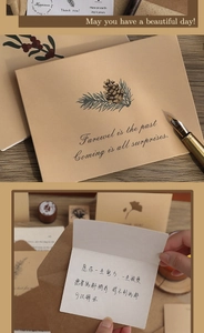 Close-up of vintage kraft envelopes with floral illustrations and pinecone details