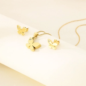 Close-up of golden butterfly jewelry set featuring sparkling crystals on the wings