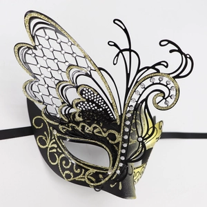 Macro detail of butterfly masquerade mask with gold glitter and embedded rhinestones