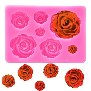 Detail of a 7-cavity pink silicone mold showing textured rose shapes and finished pieces