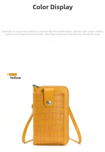 Detail view of yellow crossbody phone bag with faux crocodile texture and metal buckle