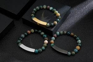Three beaded bracelets featuring natural stones with gold, silver, and black metal tubes