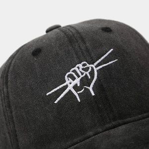 Macro shot of white embroidery and twill fabric texture on a washed baseball cap