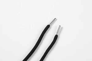 Detail of black woven drawstring with premium silver metal aglets and decorative holes