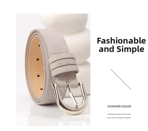 Close-up of a light grey suede belt with silver studs and a polished D-shaped metal buckle