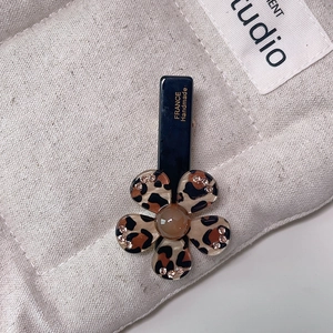 Detail of leopard print flower hair clip with rhinestones and France Handmade text