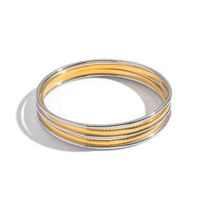 Detailed view of three-piece stainless steel bracelets in gold and silver finish