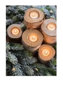 Macro detail of natural birch wood candle holders with flickering tea lights on snow