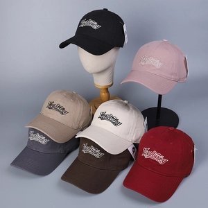 Detailed close-up of embroidered baseball caps in seven colors with Keeplucku lettering