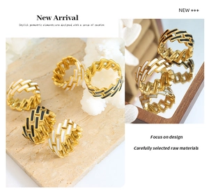 Detailed view of geometric gold chain rings with black and white enamel drip oil finish