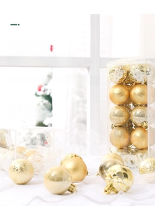 Detail of 4cm gold Christmas balls with assorted matte and glitter textures in a clear box