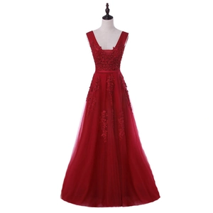 Detail of burgundy V-neck evening gown featuring intricate floral beadwork and sequin embroidery