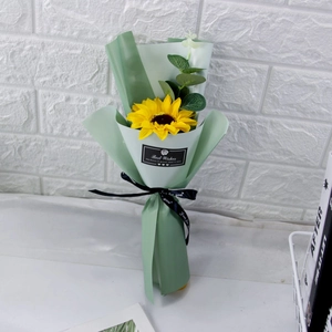 Detail of sunflower and eucalyptus soap flower bouquet in light green premium wrap