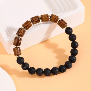 Detail of men's bracelet with brown wood beads, black hematite and gold spacers