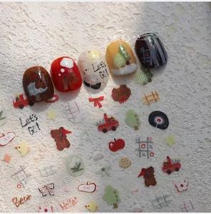 Detailed view of autumn bear nail stickers with cartoon patterns on colorful nail tips