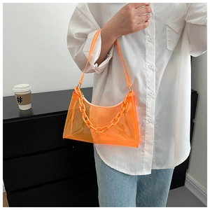 Detail of orange transparent PVC bag with a bold plastic chain strap for summer style