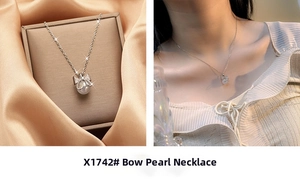 Detail of silver bow necklace with sparkling diamonds and a white pearl pendant on model