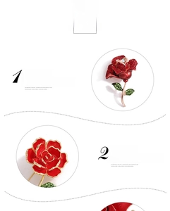Detailed macro view of a red rose brooch with gold-plated stem and green crystal leaves