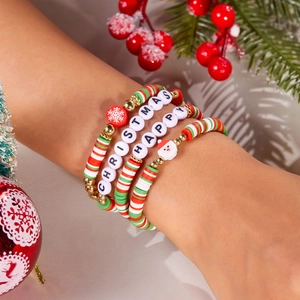 Close-up of Christmas beaded bracelets with Santa charms and festive letter beads on wrist