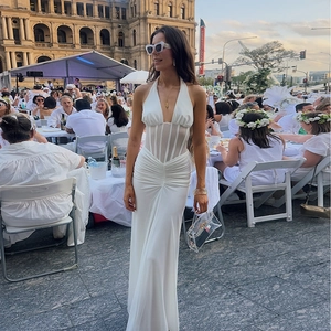 Elegant white halter neck pleated evening dress with corset waist and tiered ruffle hem