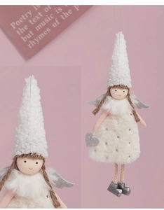 Close-up of plush Christmas angel doll with silver wings and white furry hat