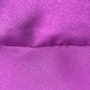 Detail shot of purple satin fabric texture with clean horizontal stitching and soft sheen