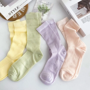 Vertical striped cotton mid-calf socks in yellow, green, purple, and pink candy colors