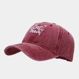 Detailed close-up of Cat Mom embroidery on a washed vintage burgundy baseball cap