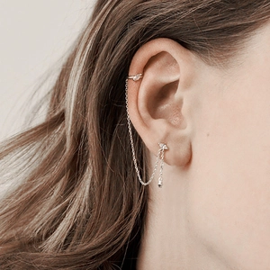 Close-up of S925 sterling silver chain earrings with opal and zircon studs on ear