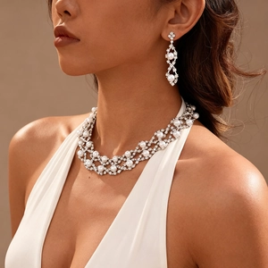 Elegant two-piece jewelry set with pearl necklace and drop earrings on a model
