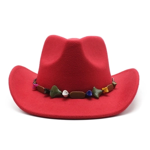 Detail of red wool cowboy hat showing ethnic style colorful beaded band and texture