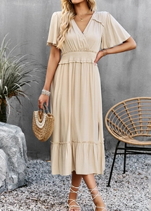 Detail of elegant V-neck beige midi dress with ruffle short sleeves and elastic high waist