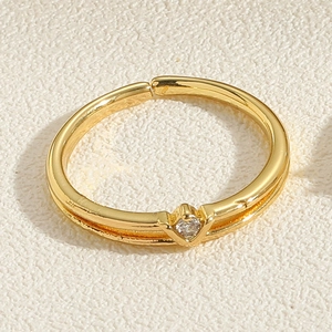 Detailed close-up of double-layered gold ring with sparkling round zircon stone