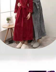Detailed close-up of thick velvet bathrobes in burgundy and dark grey waffle texture