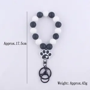 Black and white beaded bracelet keychain with silicone paw print charm and lobster clasp
