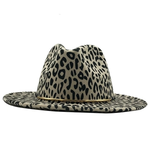 Detailed view of leopard print fedora hat featuring a stylish gold metal band decoration
