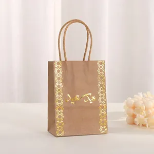 Detail of kraft paper gift bag with gold foil Islamic geometric patterns and Arabic script