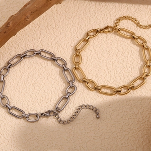 Detail showing gold and silver paperclip link anklets with adjustable lobster clasps