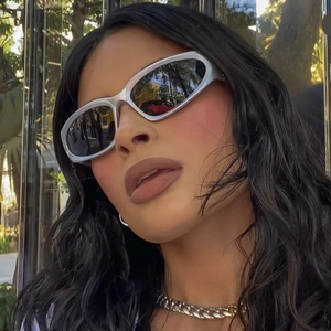 Detail of silver futuristic steampunk sunglasses with grey lenses on fashion model