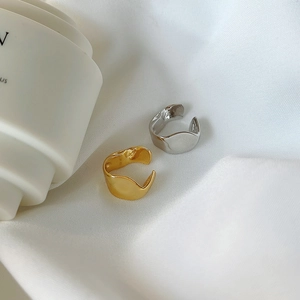 Irregular liquid metal ear clips in silver and gold, minimalist wave-shaped cuff earrings