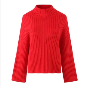 Detailed close-up of the red rib-knit texture and high-neck design of the sweater