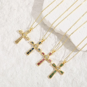 Macro shot of 14K gold-plated cross pendants with colorful rectangular-cut zircons