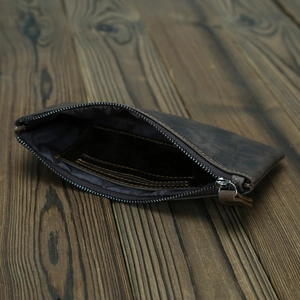 Detail view of crazy horse leather wallet interior with card slot on wooden surface