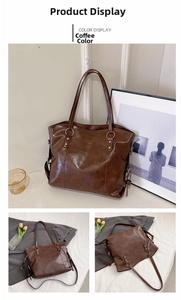 Detail view of large brown faux leather tote bag with stylish strap and gold hardware
